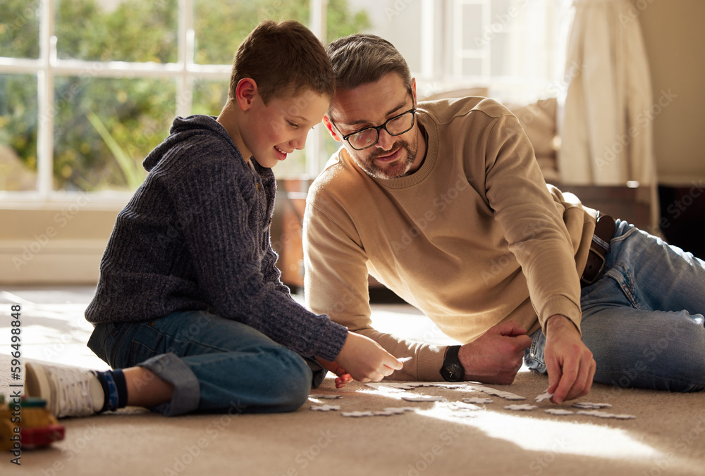 Sticker Which puzzle piece goes in there. Shot of a father and son bonding on the lounge floor at home.