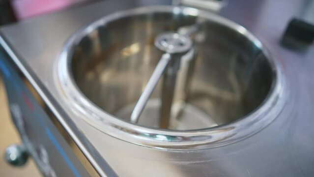Deep ice cream pasteurization steel batch machine for mixing ingredients in a kitchen. High-quality 4k footage