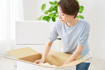 引っ越しの荷造りをする女性