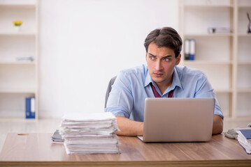 Young male employee working in the office