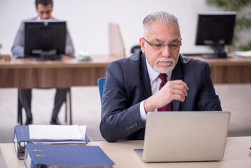 Two male colleagues working in the office