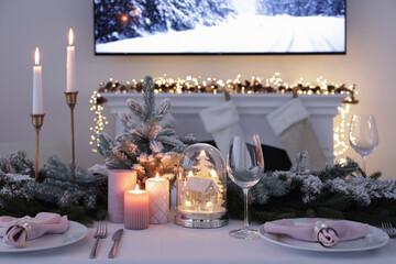 Beautiful festive table setting with Christmas decor in room