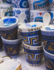 Poster View of traditional tourist souvenirs and gifts from Athens, Attica, Greece with fridge magnets with text "Greece", "Athens" and key ring keychain, in a local vendor shop  © tsuguliev