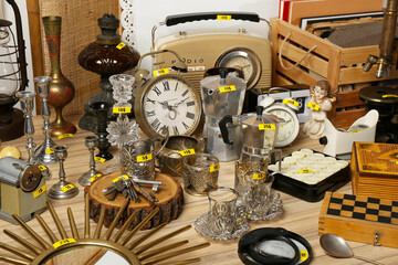 Many different items on wooden table. Garage sale
