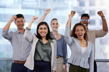 We outperformed, it paid off. Portrait of a group of young businesspeople cheering in a modern office.