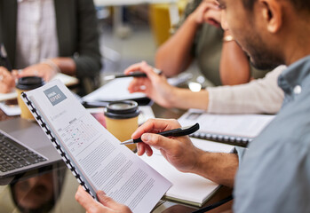 Always read the fine print. Shot of a businessman reviewing paperwork during a meeting.