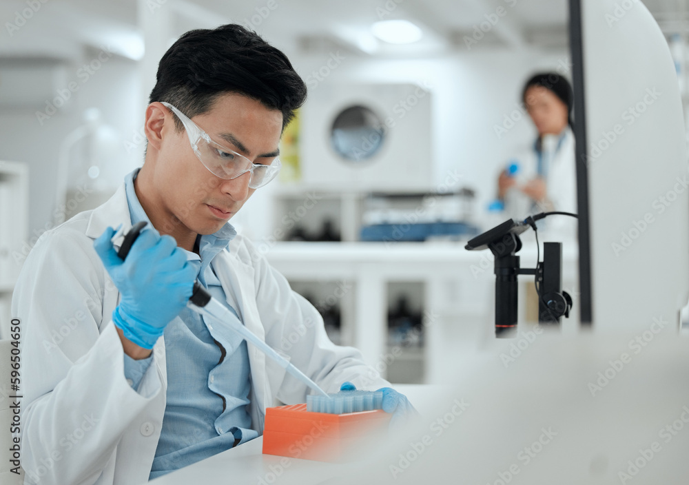Poster being careful when working with samples. shot of a young man filling a test tube samples.