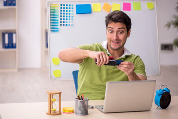 Young male designer sitting in the office