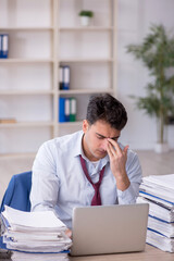 Naklejka premium Young male employee working in the office