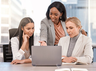 Days like these are what I live for. Shot of a group of businesswomen working together while using a laptop.