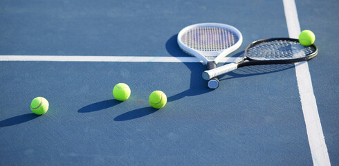 Is that health calling your name. Shot of two tennis rackets and tennis balls on a court during the...
