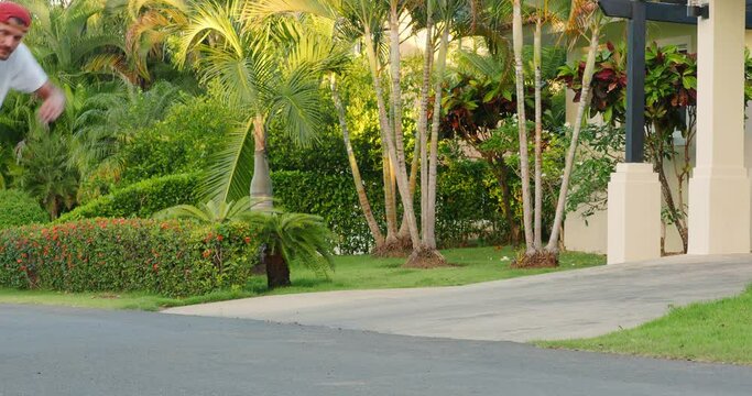 Skateboarder dude rides on skateboard at street surf style. 