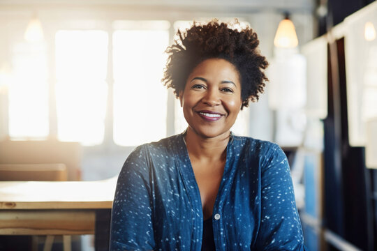 Portrait of mature curvy Black small business woman owner in her artist studio. Generative AI.