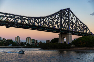 famous story bridge in brisbane at sunset; red sunset over brisbane cbd, queensland, australia