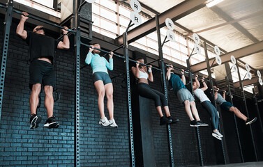 As many reps as we can. Shot of a group of people completing pull ups together.