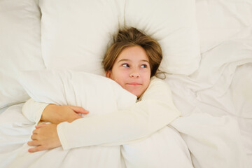 Little beautiful girl in pajamas sleeping in bed