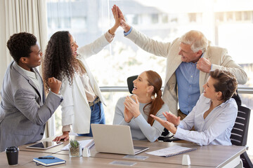 Now thats how its done. Shot of a diverse group of businesspeople celebrating a success during a meeting in the office.