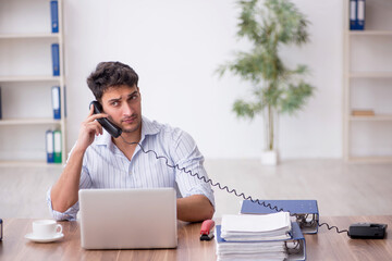 Young male employee working in the office