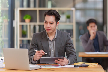 Accountant man working on digital tablet and do document, tax, exchange, research, accounting and Financial advisor concept