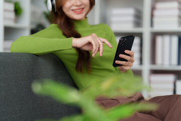 Attractive Asian woman resting comfortable living room and using mobile phone, Relax, Sofa, Lifestyle