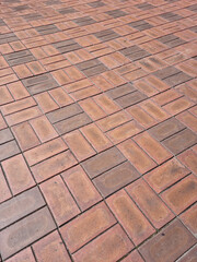close up textured red brick walkway.