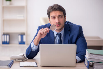 Young male employee working in the office