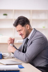 Naklejka premium Young male employee working in the office