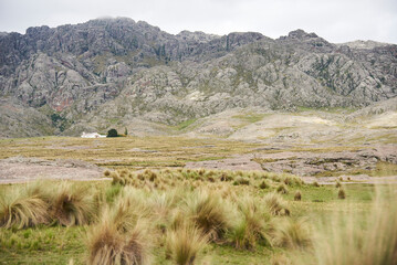 Mountainous landscape with house in Los Gigantes, a mountain massif that belongs to the northern area of the Sierras Grandes, a tourist destination for hiking, trekking, in Cordoba, Argentina