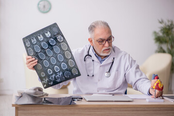 Old male doctor radiologist working at the hospital