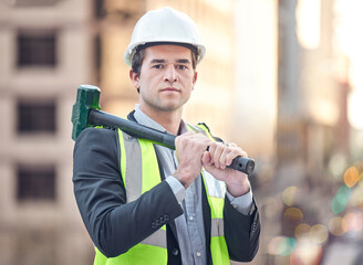 Im here to do a complete rebuild. Cropped portrait of a handsome male construction worker standing with a hammer on a building site.