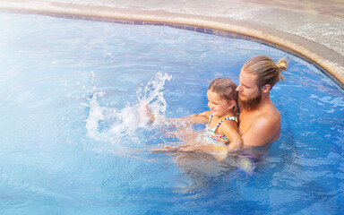 Dad and daughter in the water splashing
