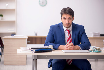 Young male employee working in the office