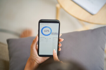 Woman checking Financial on smartphone Human hand holding mobile phone working from home