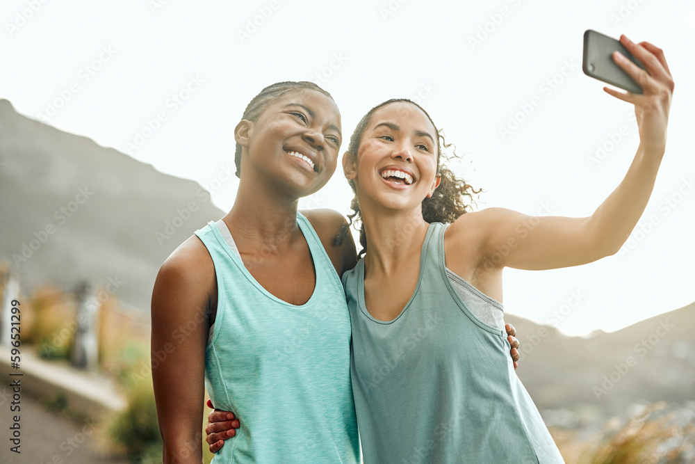 Canvas Prints Building our dream bodies together. Shot of two friends taking selfies during a workout.