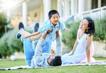 Fun times, family times. Shot of a young family relaxing in their garden outside.