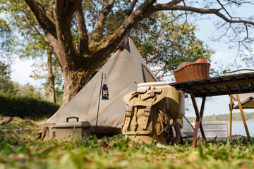 Outdoor Camping Table set with nature beside tent campsite. Travel and camping concept