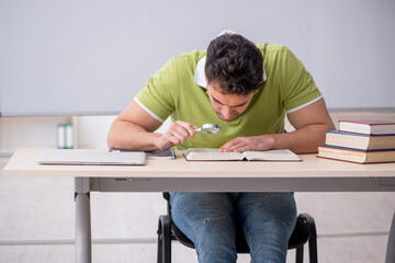 Young male student sitting in the classroom