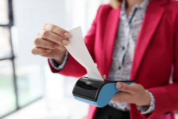 Administrator tears off purchase receipt after e-payment