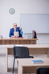 Old male teacher in the classroom