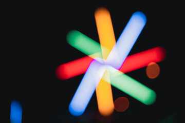 Blur background of lighting show annual temple night event. Bright neon lights