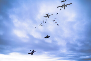 Skydive formation with two airplanes and clouds