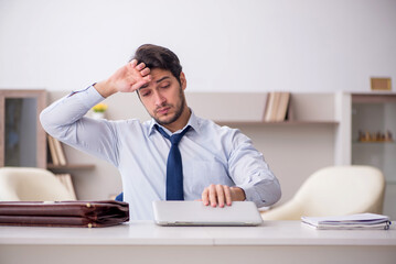 Young male employee working from home during pandemic