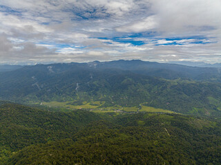 Top view of mountains with evergreen vegetation. Tropical landscape. Sumatra, Indonesia.