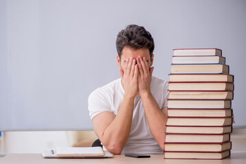 Young male student sitting in the classroom