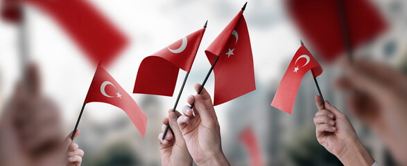 A group of people holding small flags of the Turkey in their hands - obrazy, fototapety, plakaty