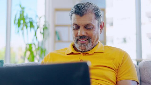 Senior man, laptop and smile in home living room, social media or typing online. Computer, retirement and happiness of male person with technology for streaming movie, film or video on lounge sofa.