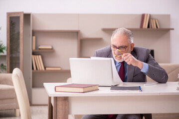 Old male employee working from home during pandemic