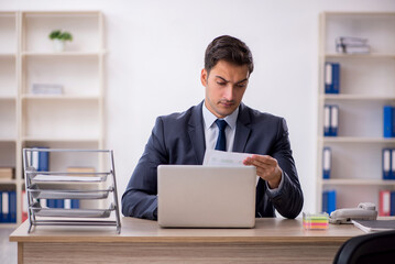 Young male employee working in the office