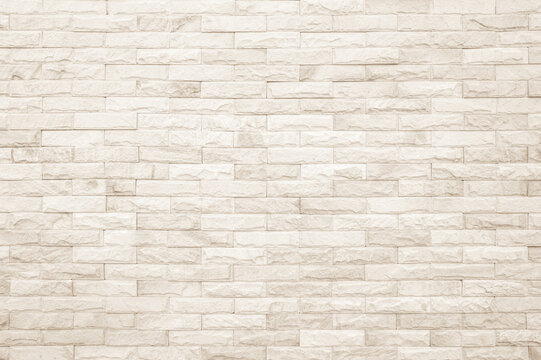 Empty background of wide cream brick wall texture. Beige old brown brick wall concrete or stone textured, wallpaper limestone abstract.