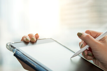Digital signature, electronic note taking. Close up view of woman holding stylus pen signing...